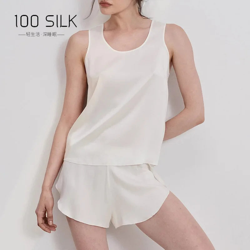 Woman wearing a white silk outfit with '100 SILK' branding on a light background