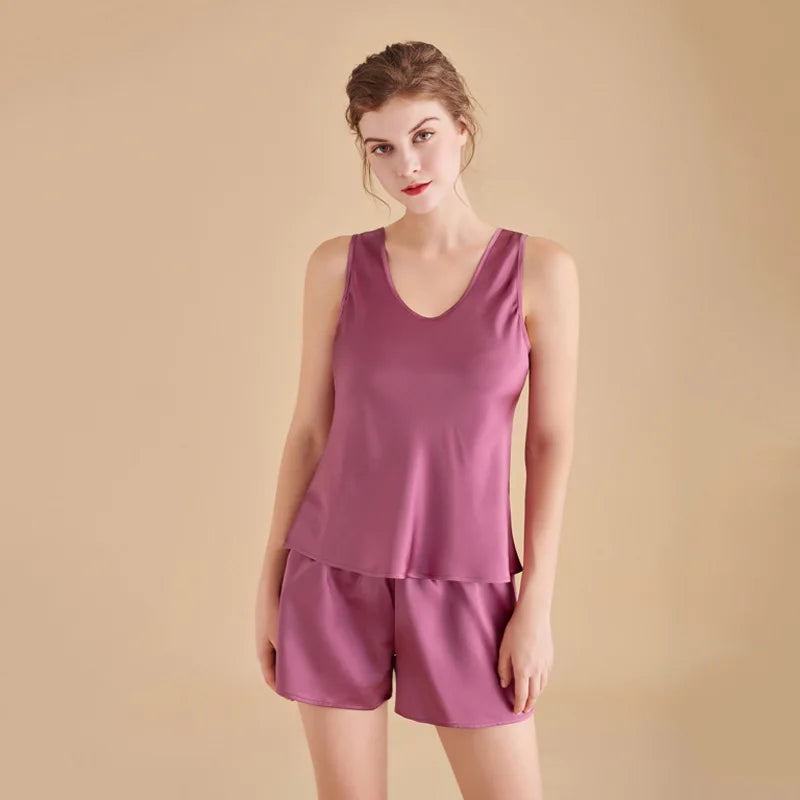 Woman wearing a purple tank top and shorts set against a beige background