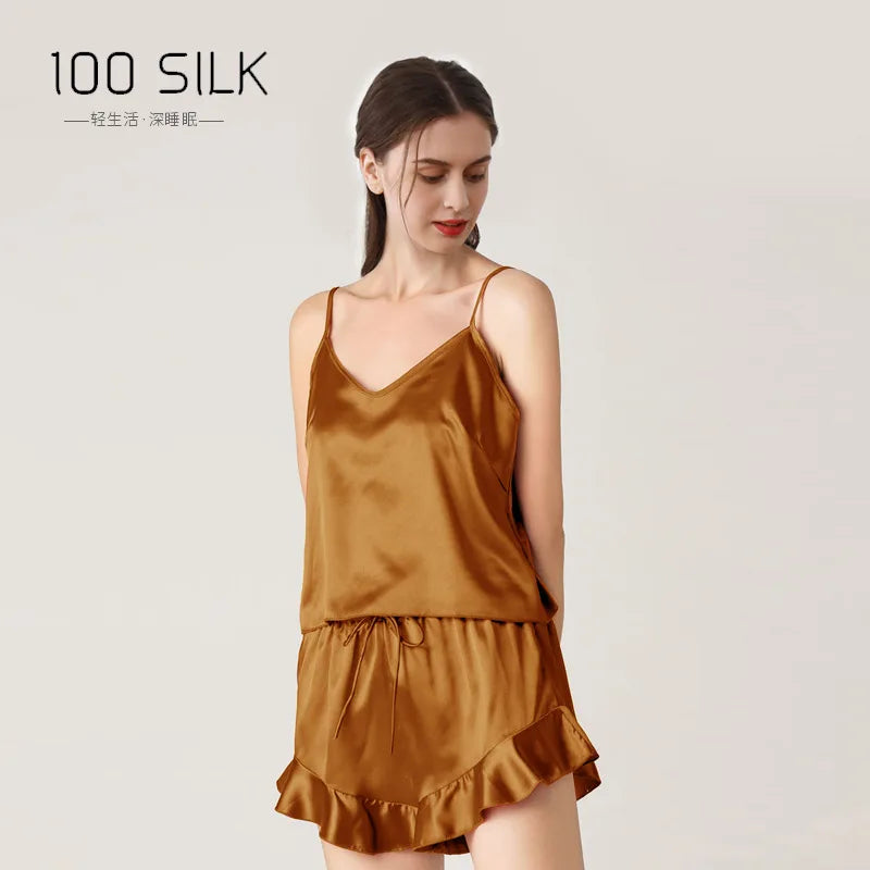 Woman wearing a brown silk nightgown with '100 Silk' branding on a light background