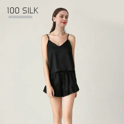 Woman wearing a black silk dress with '100 Silk' text on a light gray background