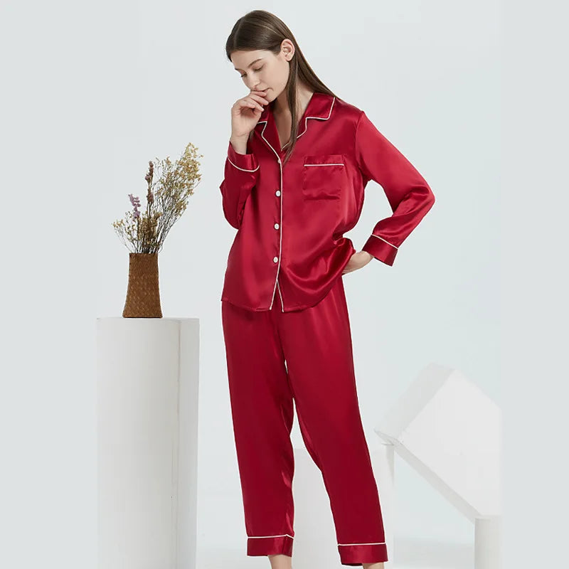 Woman wearing red blue pajamas with white trim on a white background