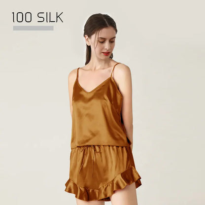 Woman wearing a brown silk slip dress with '100 Silk' text above on a light beige background