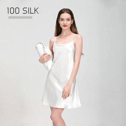 Woman wearing a white silk dress holding a matching bag on a gray background with '100 SILK' text.