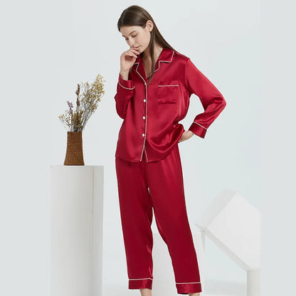 Woman wearing red satin pajamas on a white background