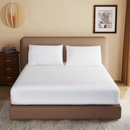 Bed with white bedding and brown frame in a room setting