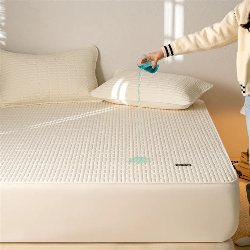 Person pouring water onto a mattress protector on a bed