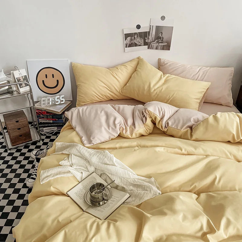 Neatly made bed with yellow bedding in a room with a checkered floor.