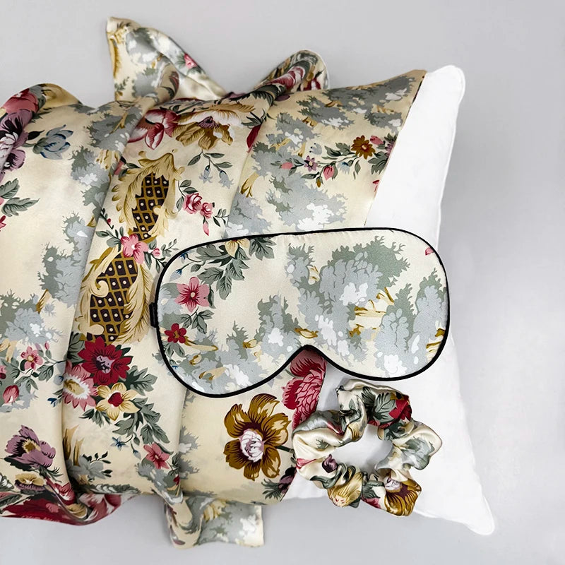Floral-patterned eye mask and pillow set on a light gray background