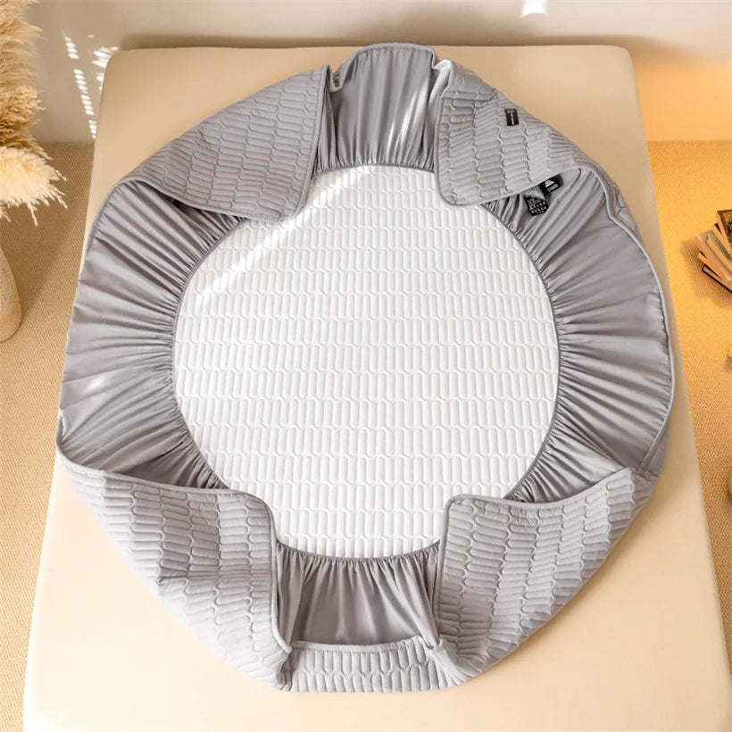 Gray crib sheet on a crib with a white mattress
