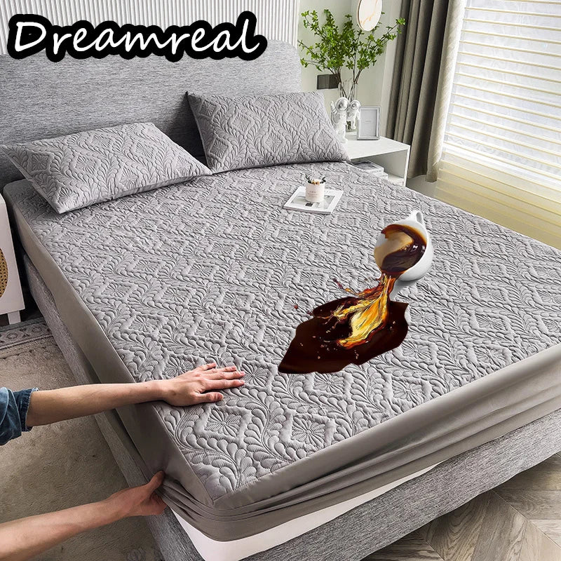 Gray textured mattress cover on a bed with a person's hands lifting it, showing a coffee cup and saucer underneath.